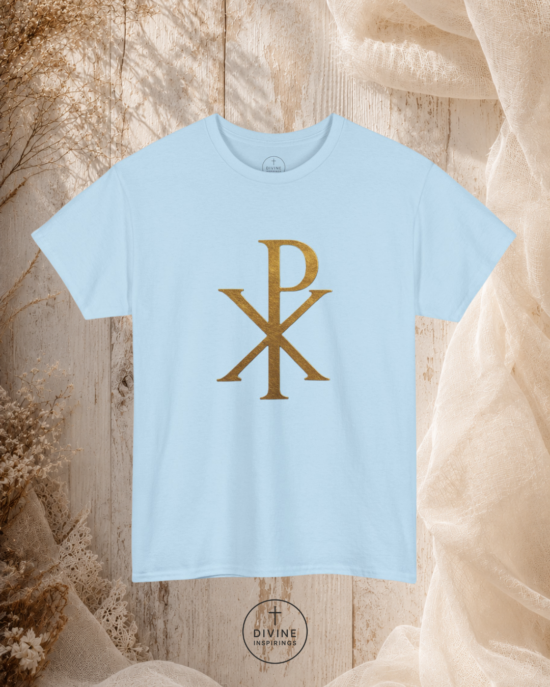 Light blue t-shirt with gold symbol on a textured beige background