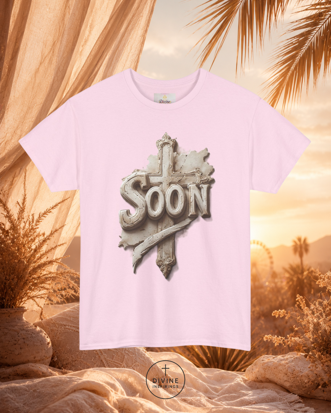 Pink t-shirt with 'SOON' graphic design against a desert sunset background