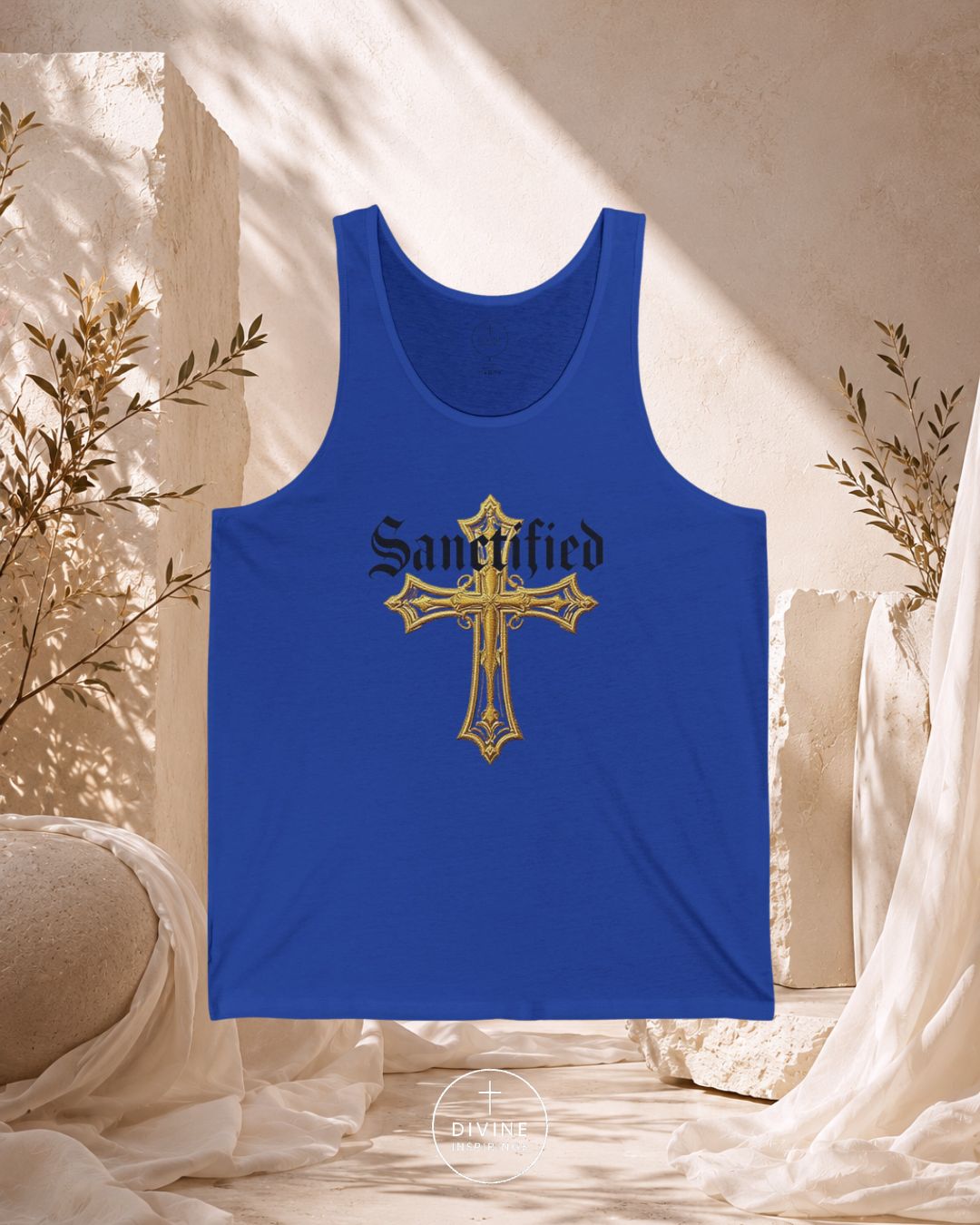Blue tank top with gold cross and 'Sainted' text on a neutral background