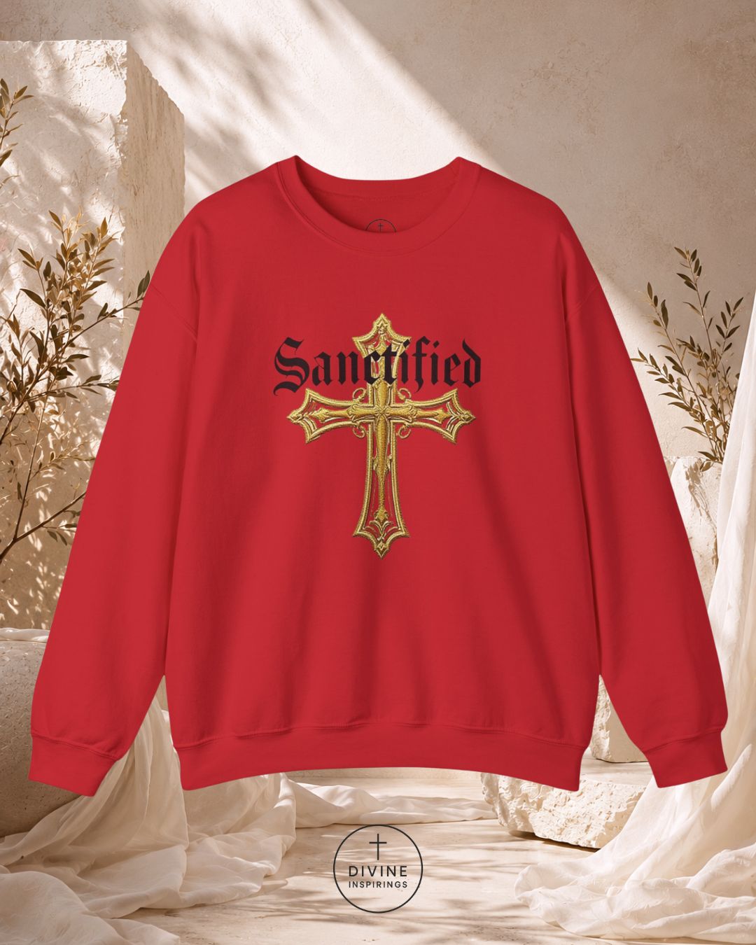 Red sweatshirt with gold cross design and 'Sanctified' text on a neutral background