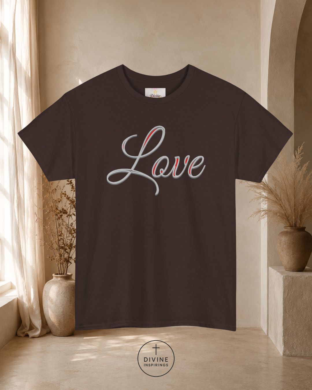 Black t-shirt with 'Love' printed on it in a room with decorative plants and a neutral color scheme.