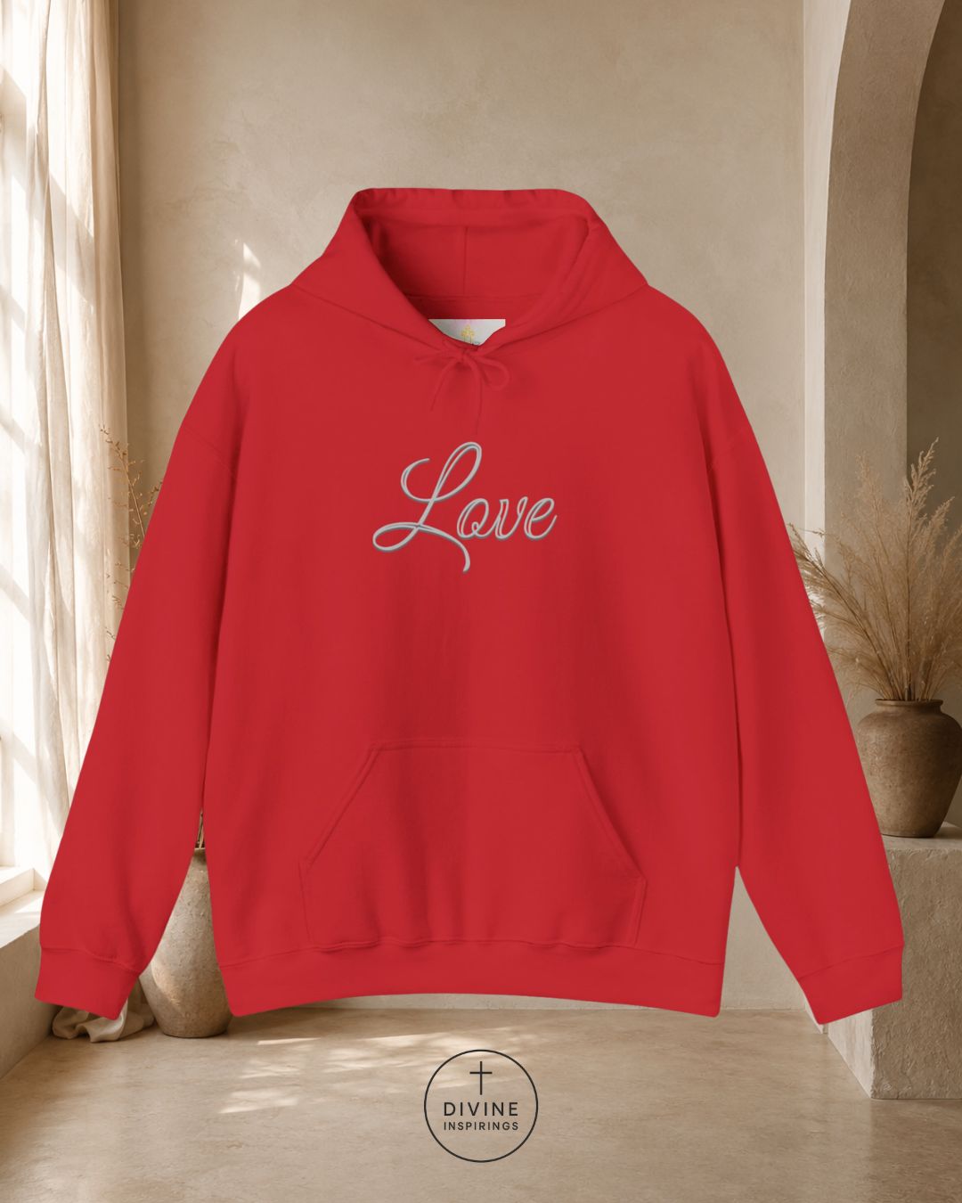 Red hoodie with 'Love' text in a neutral indoor setting