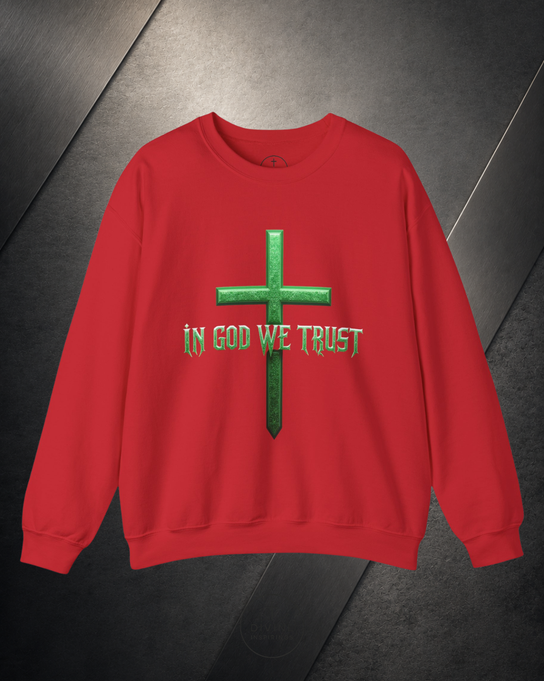 Red sweatshirt with a green cross and 'In God We Trust' text on a dark surface