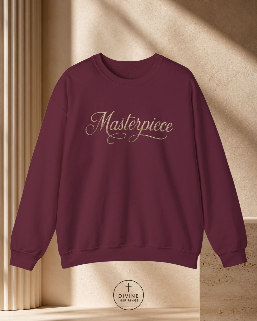Maroon sweatshirt with 'Masterpiece' text on a beige background