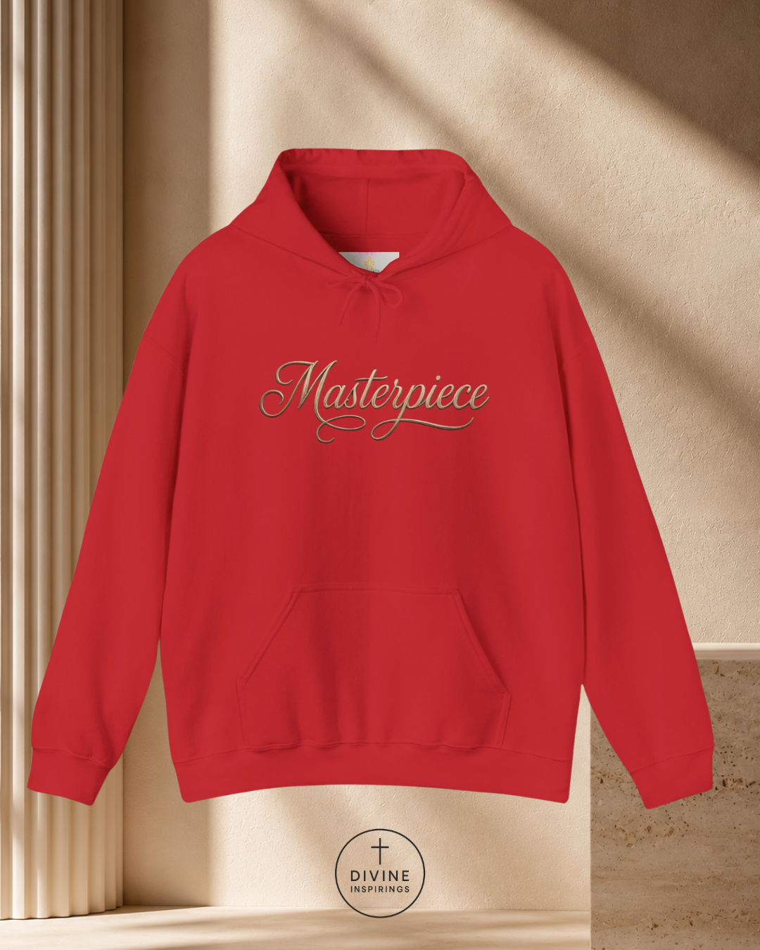 Red hoodie with 'Masterpiece' text on a beige background