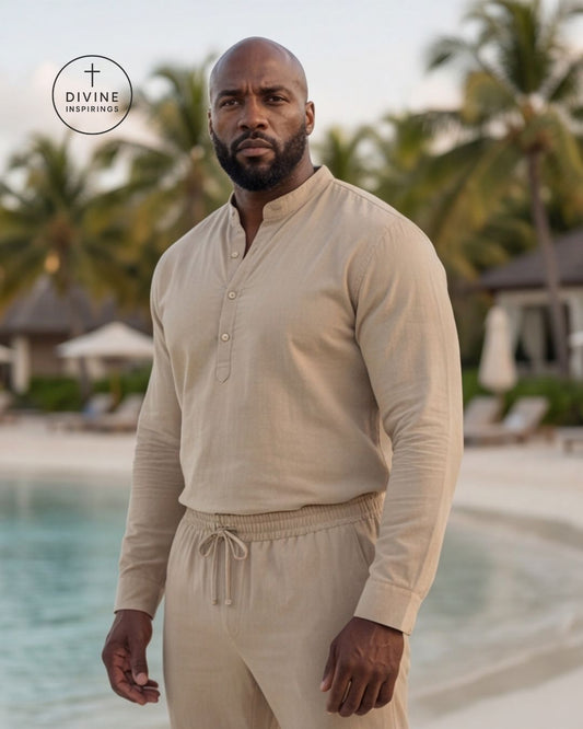 A man wearing a beige long-sleeve button-front shirt and matching drawstring pants stands by a tropical pool with palm trees in the background. A circular DIVINE INSPIRINGS' logo appears in the upper left corner.