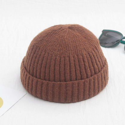 Brown knitted beanie on a white background