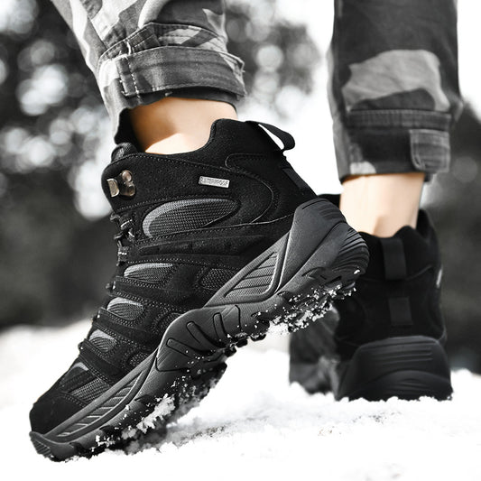 Black hiking boots being worn in a snowy environment