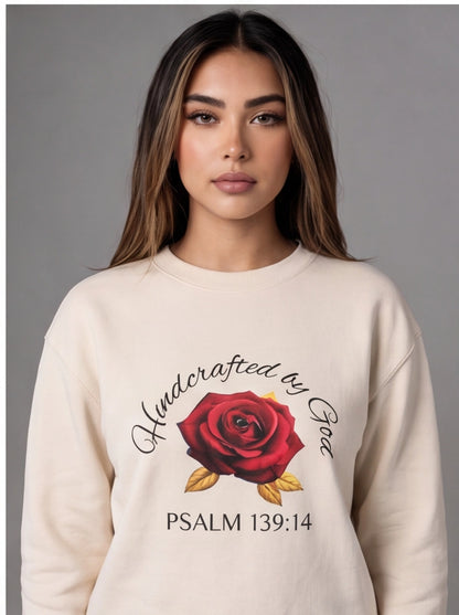 Woman wearing a cream sweatshirt with a red rose design and text on a gray background