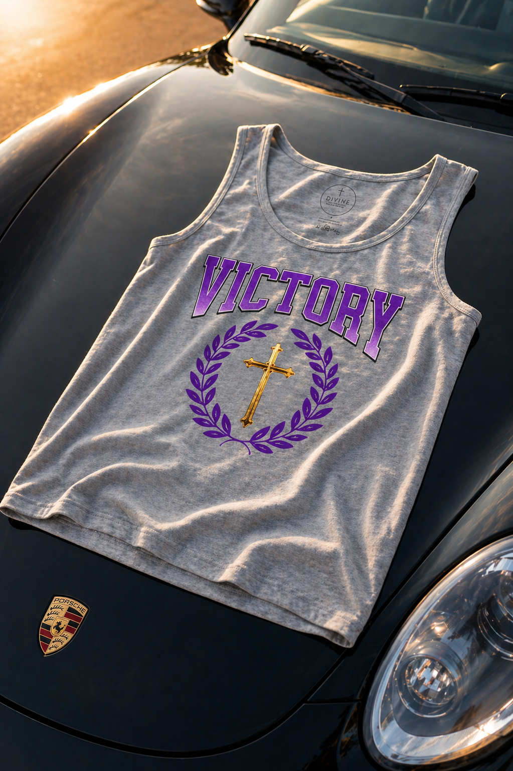 Gray tank top with 'VICTORY' and cross design on a car hood