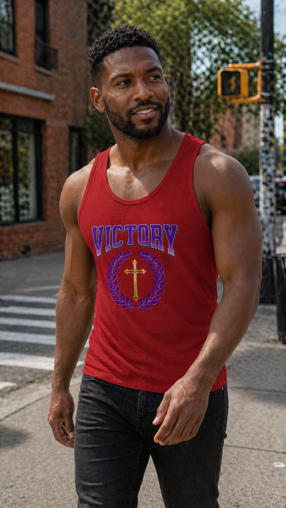 Man wearing a red tank top with 'Victory' printed on it, standing on a city street.