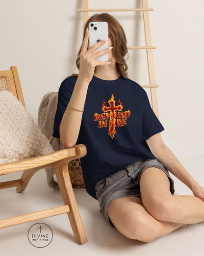 Person wearing a navy blue t-shirt with a red and orange graphic design, sitting on the floor.