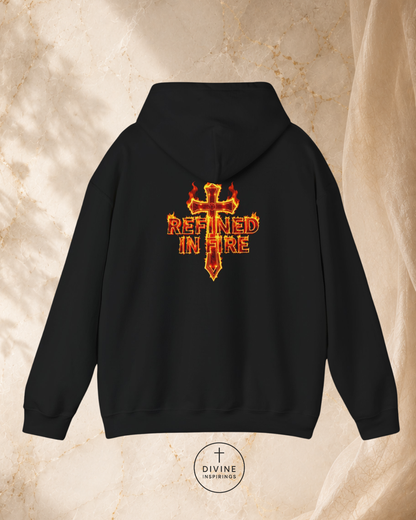 Black hoodie with 'Refined in Fire' design on the back against a beige marble background.