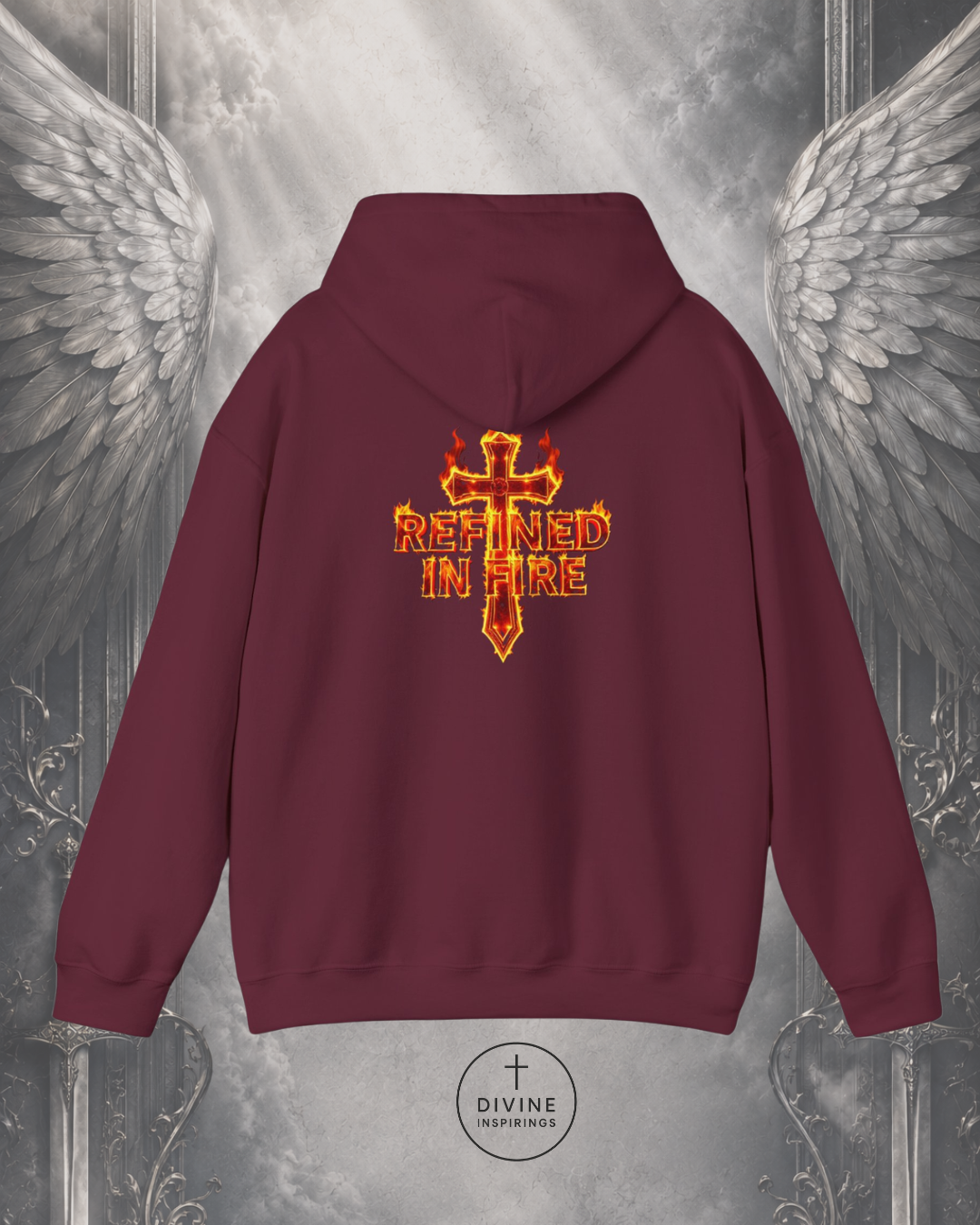 Maroon hoodie with 'Refined in Fire' design on the back against a metallic angel wings background.