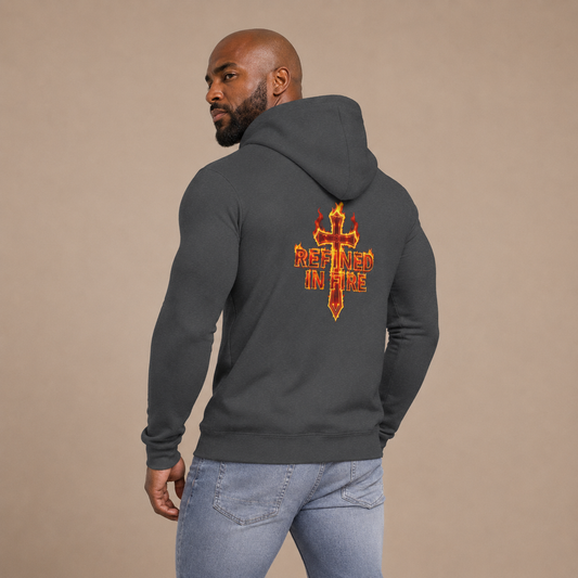 Man wearing a dark gray hoodie with a fiery cross design on the back against a beige background