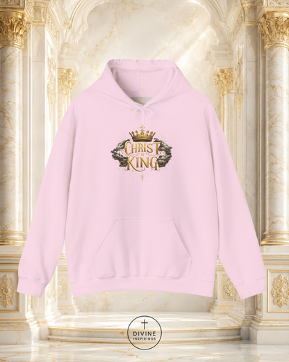 Pink hoodie with 'Christ King' design on a decorative background