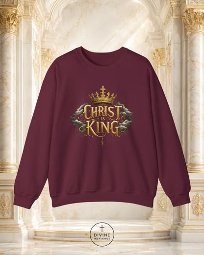 Maroon sweatshirt with 'Christ King' design in gold and green on a decorative background