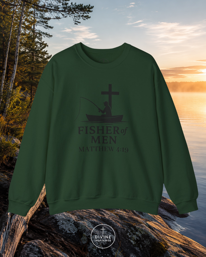 Green sweatshirt with 'Fisher of Men' design on a rock by a lake at sunset