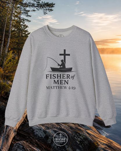 Gray sweatshirt with 'Fisher of Men' design on a rock by a lake at sunset