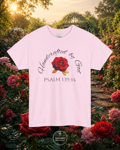 White t-shirt with red rose graphic and text in a garden setting