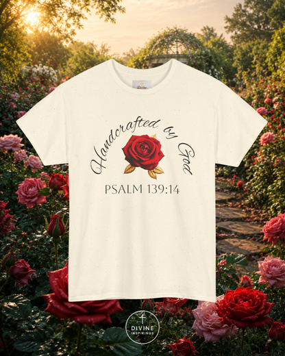 White t-shirt with red rose graphic and text in a garden setting