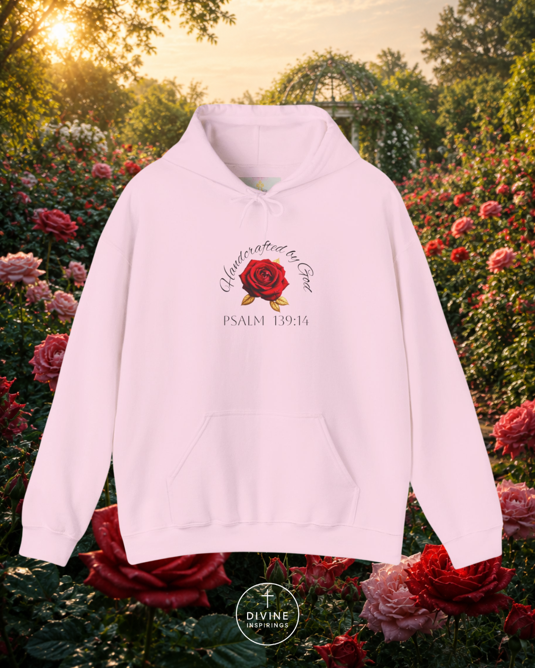Pink hoodie with a rose design and text in a garden setting