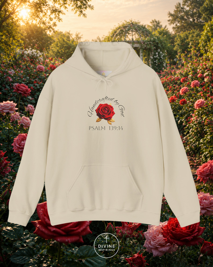 Beige hoodie with a rose design and text in a garden setting