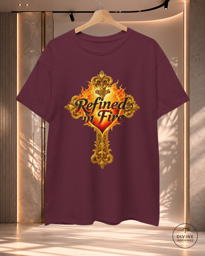 Maroon t-shirt with 'Refined in Fire' design on a hanger against a neutral background