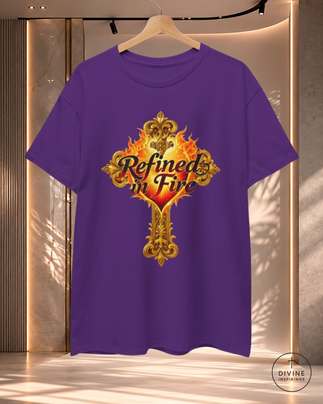 Purple t-shirt with 'Refined in Fire' design on a hanger against a neutral background