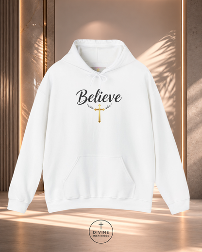 White hoodie with 'Believe' and cross design on a wooden background