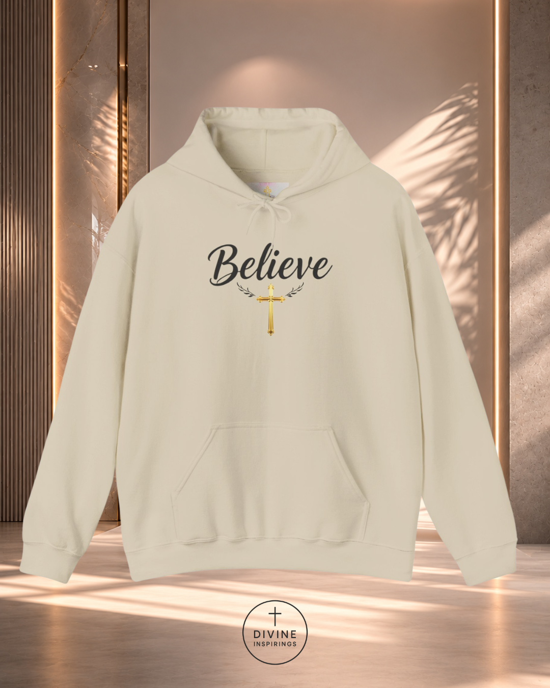 Beige hoodie with 'Believe' text and cross design on a neutral background