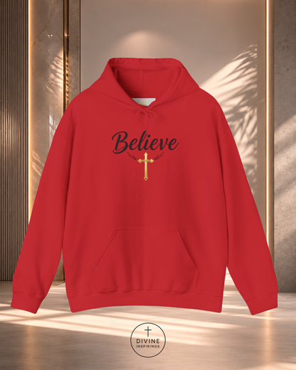 Red hoodie with 'Believe' and cross design on a reflective surface