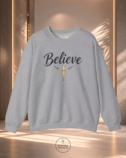 Gray sweatshirt with 'Believe' and a cross design on a neutral background