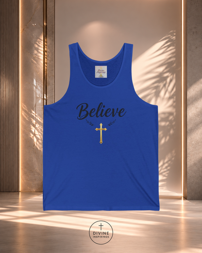 Blue tank top with 'Believe' and cross design on a textured wall background