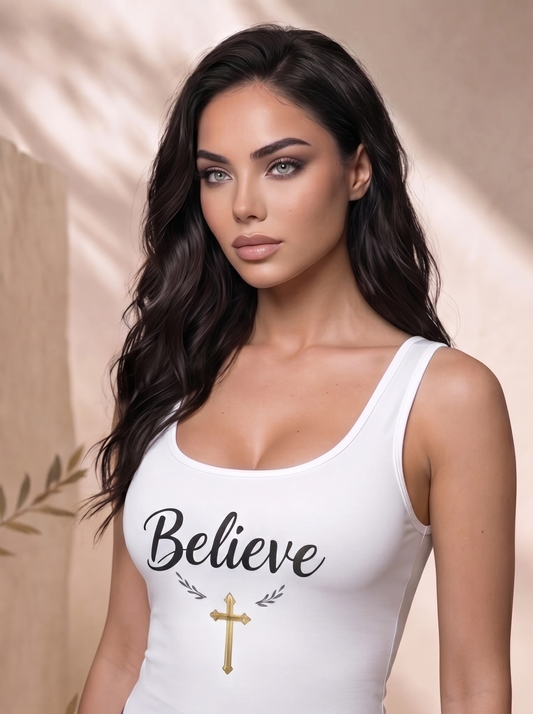 Woman wearing a white tank top with 'Believe' and a cross design on a beige background