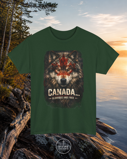 Black t-shirt with a wolf graphic and 'Canada Glorious and Free' text, placed on rocks by a lake.