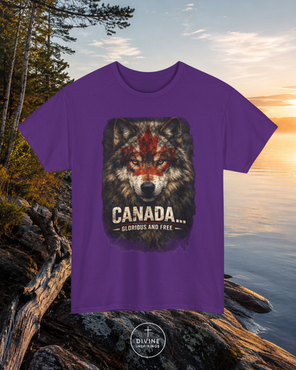 Purple t-shirt with a wolf graphic and 'Canada Glorious and Free' text, placed on rocks with a lake and trees in the background.