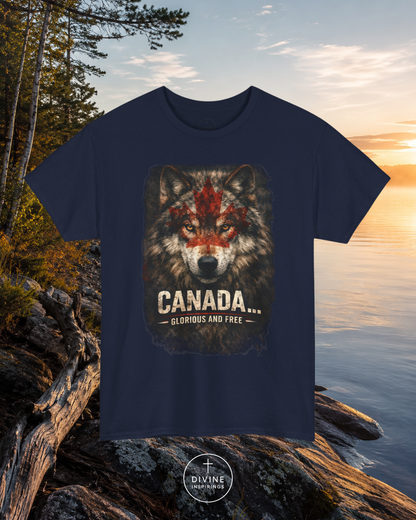 Navy blue t-shirt with a wolf graphic and 'Canada Glorious and Free' text, placed on rocks by a lake.