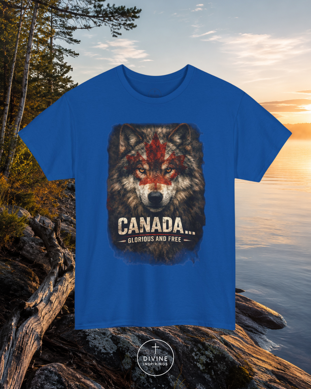 Blue t-shirt with a wolf graphic and 'Canada Glorious and Free' text on rocks by a lake.