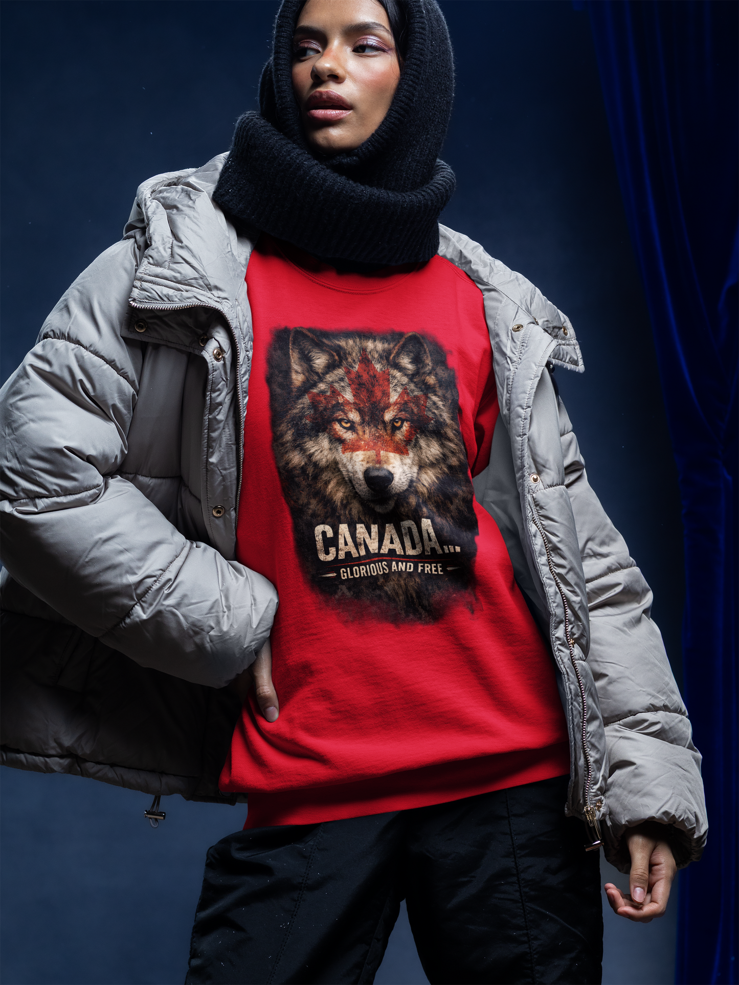 Person wearing a red sweatshirt with a wolf graphic and 'Canada' text against a dark background
