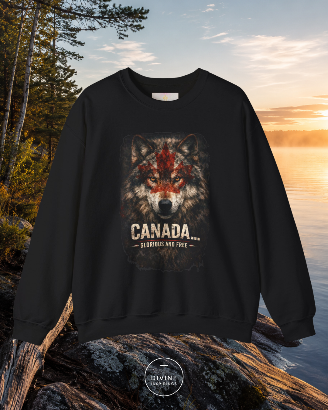 Black sweatshirt with wolf design and 'Canada' text on a rock by a lake at sunset.