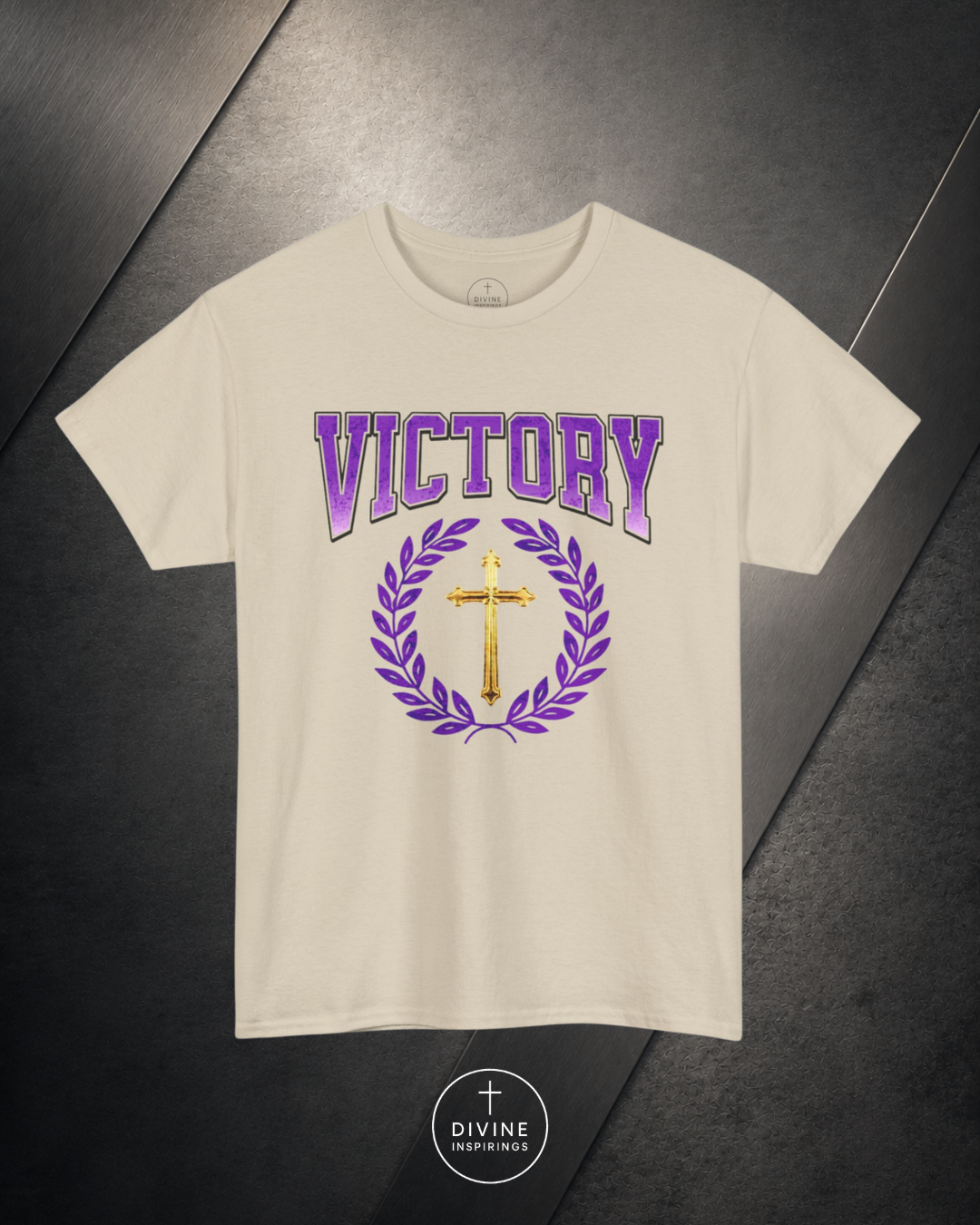 Beige t-shirt with 'VICTORY' text and cross design on a dark surface