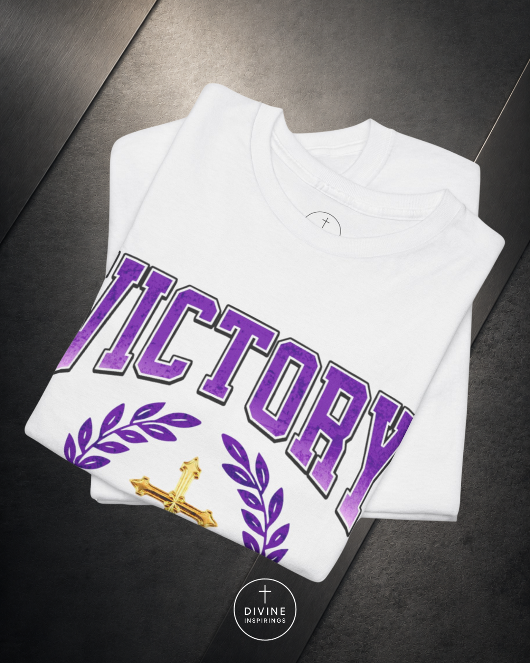 Pink sweatshirt with 'VICTORY' printed in purple on a dark surface