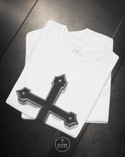 White t-shirt with a black cross design on a dark surface