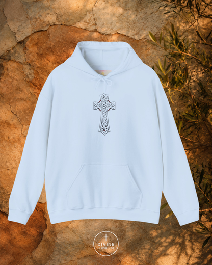Light blue hoodie with a cross design on a stone surface