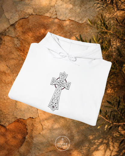White garment with a black cross design on a textured stone surface