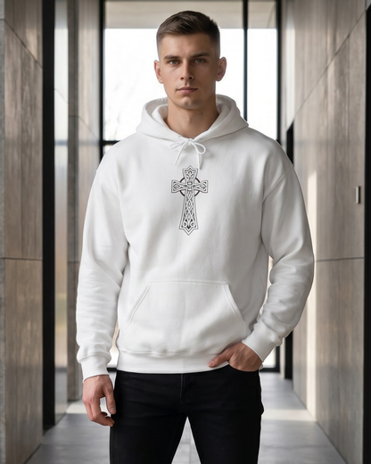 Man wearing a white hoodie with a cross design in a modern indoor setting