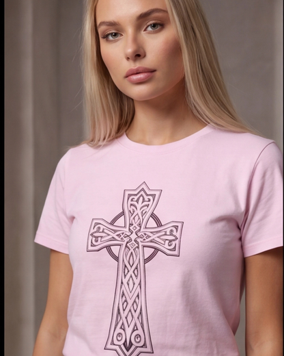 Woman wearing a pink t-shirt with a Celtic cross design against a neutral background