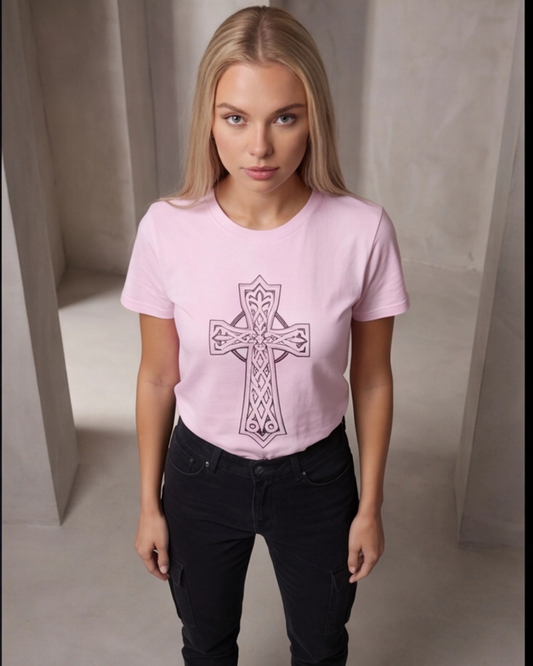Woman wearing a pink t-shirt with a cross design against a neutral background