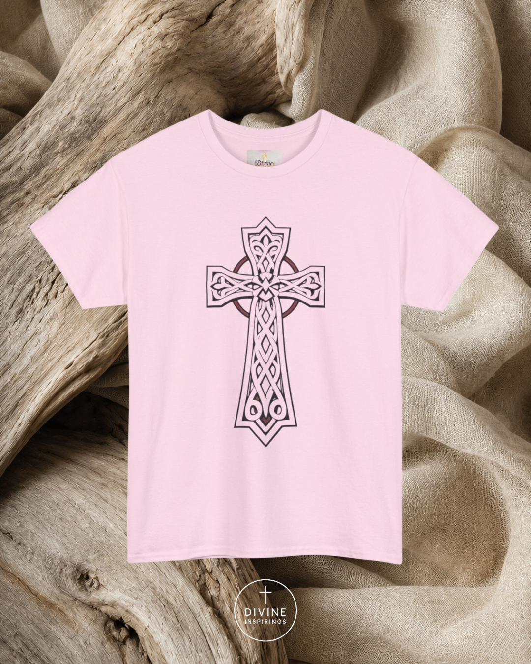 Pink t-shirt with a black cross design on a textured beige background